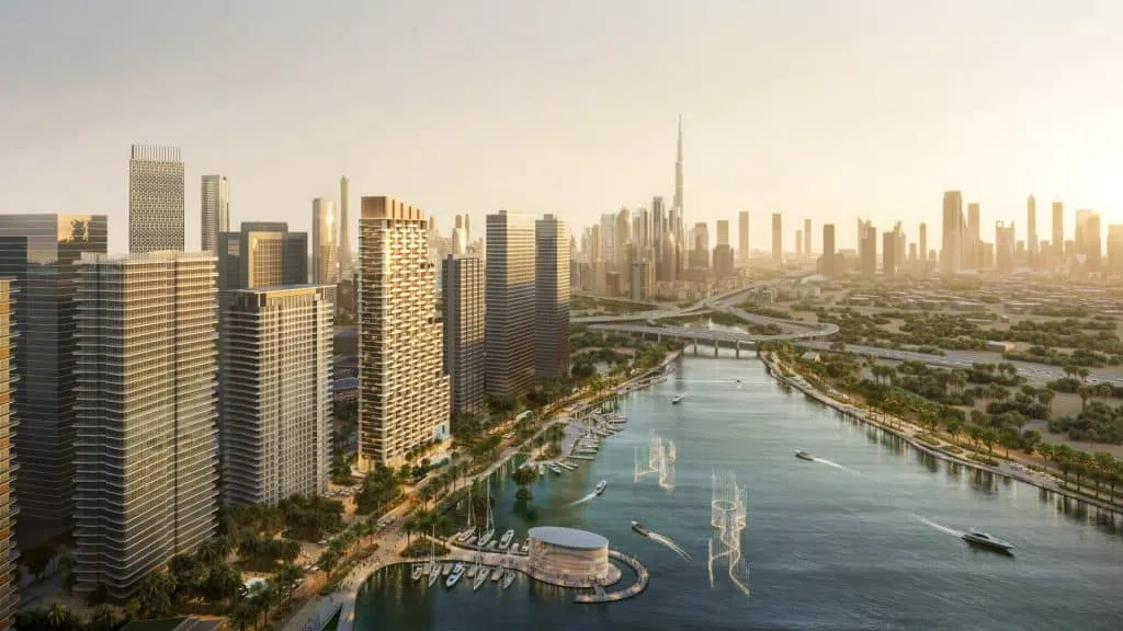 Dubai skyline featuring Burj Khalifa and waterfront canal surrounded by modern skyscrapers.